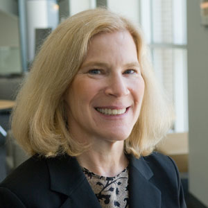 Deborah Turner, associate professor of Accounting, smiles in a black suit jacket
