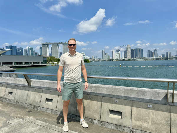 student posing in front of a city skyline