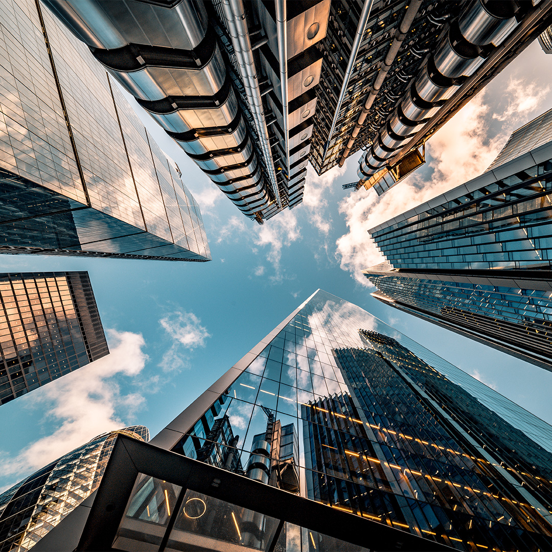 A low-angle view of skyscrapers against a blue sky