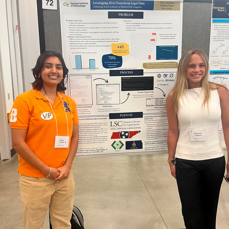 Students presenting in front of poster session