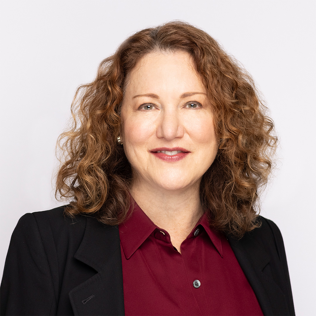 Sheila Aharoni, B.S. Industrial Management ‘79, smiles in a black jacket