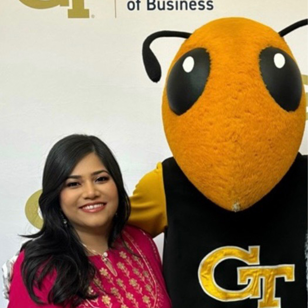 A women posing with a mascot