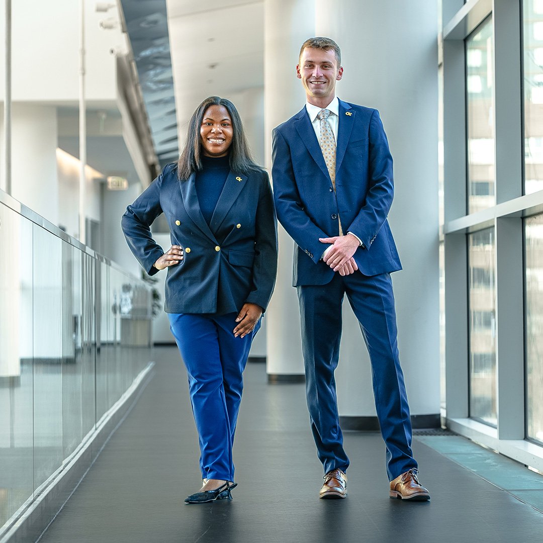 A man and a woman in blue suits