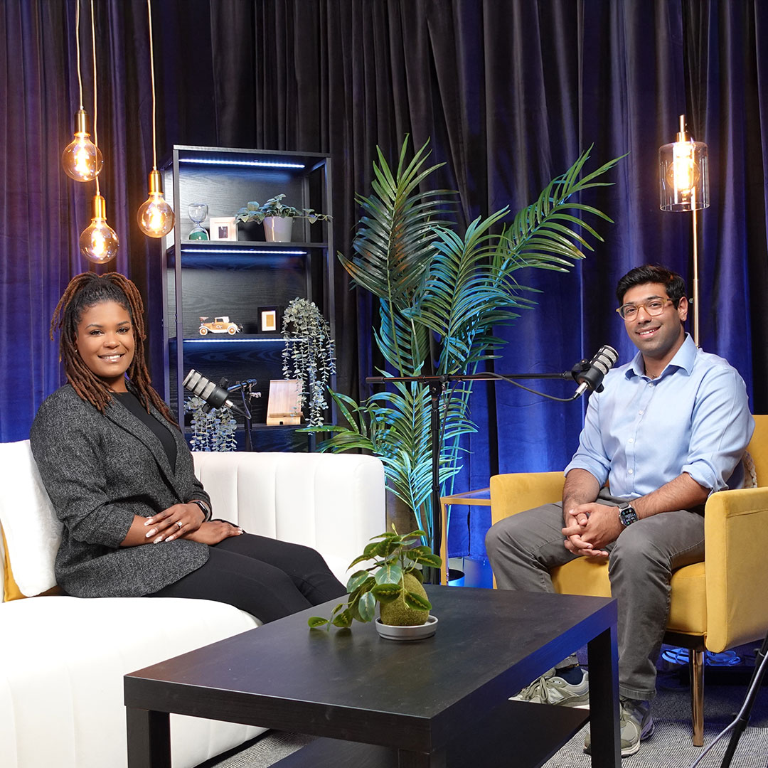 MBA students Analisa Wade and Prem Rupawala sitting down to record a podcast episode. 