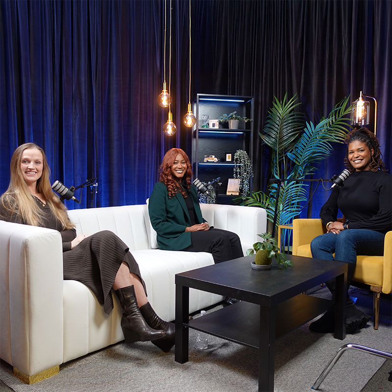 Brin McFall, Chasten McCrary, and Analisa Wade in a room speaking into microphones