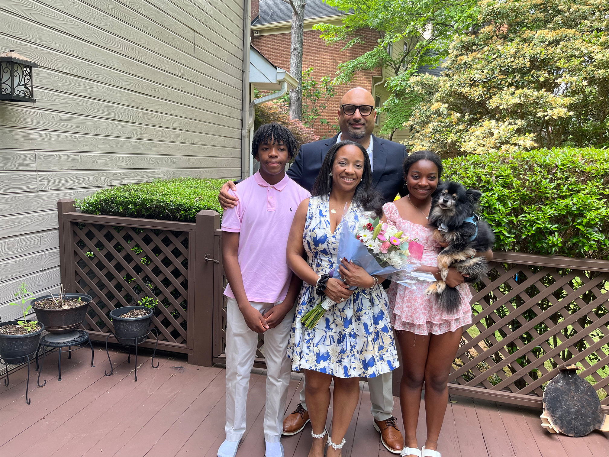 Kaden Kenner, Eudon Robinson, Dr. Brandi Biscoe Kenner, Amina Kenner, and Kirby the Pomeranian celebrate Mother’s Day in 2024.