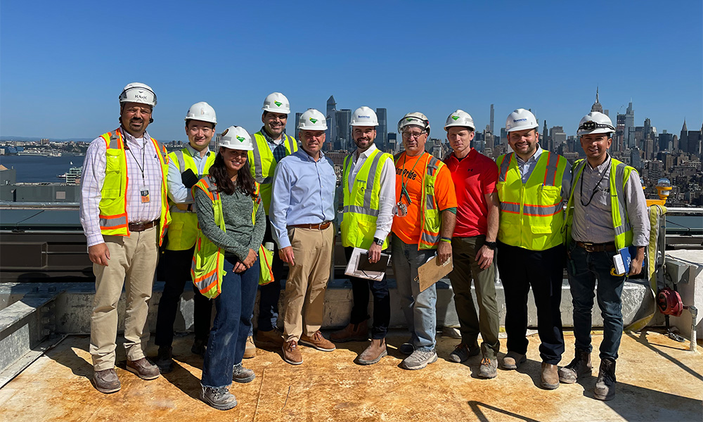 Corey Conklin (center) on top of The Walt Disney Company’s 1.3-million-square-foot NYC headquarters. 