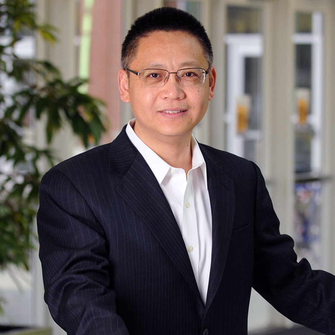 D.J.  Wu, professor of information technology management poses for a headshot photo in a dark suit jacket and white collared shirt.