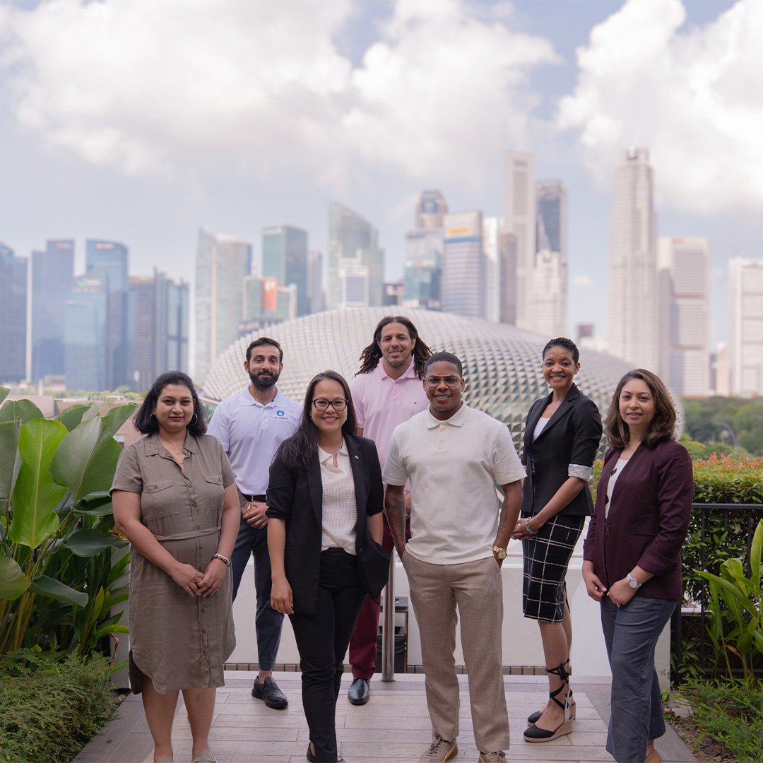 Executive MBA students gather with the Singapore cityscape in the background.