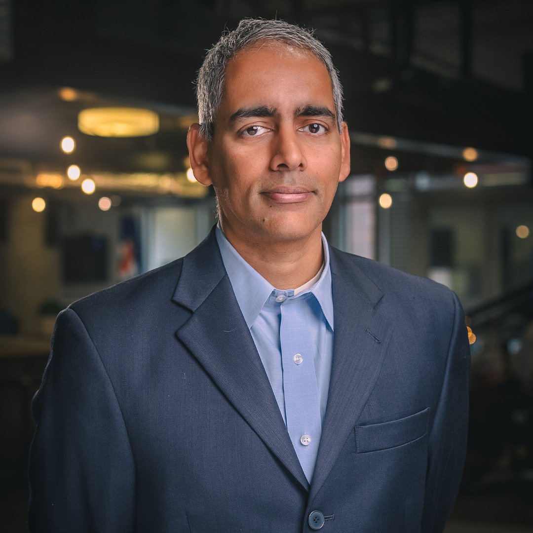 Karthik Ramachandran, operations management professor, smiles in a suit jacket