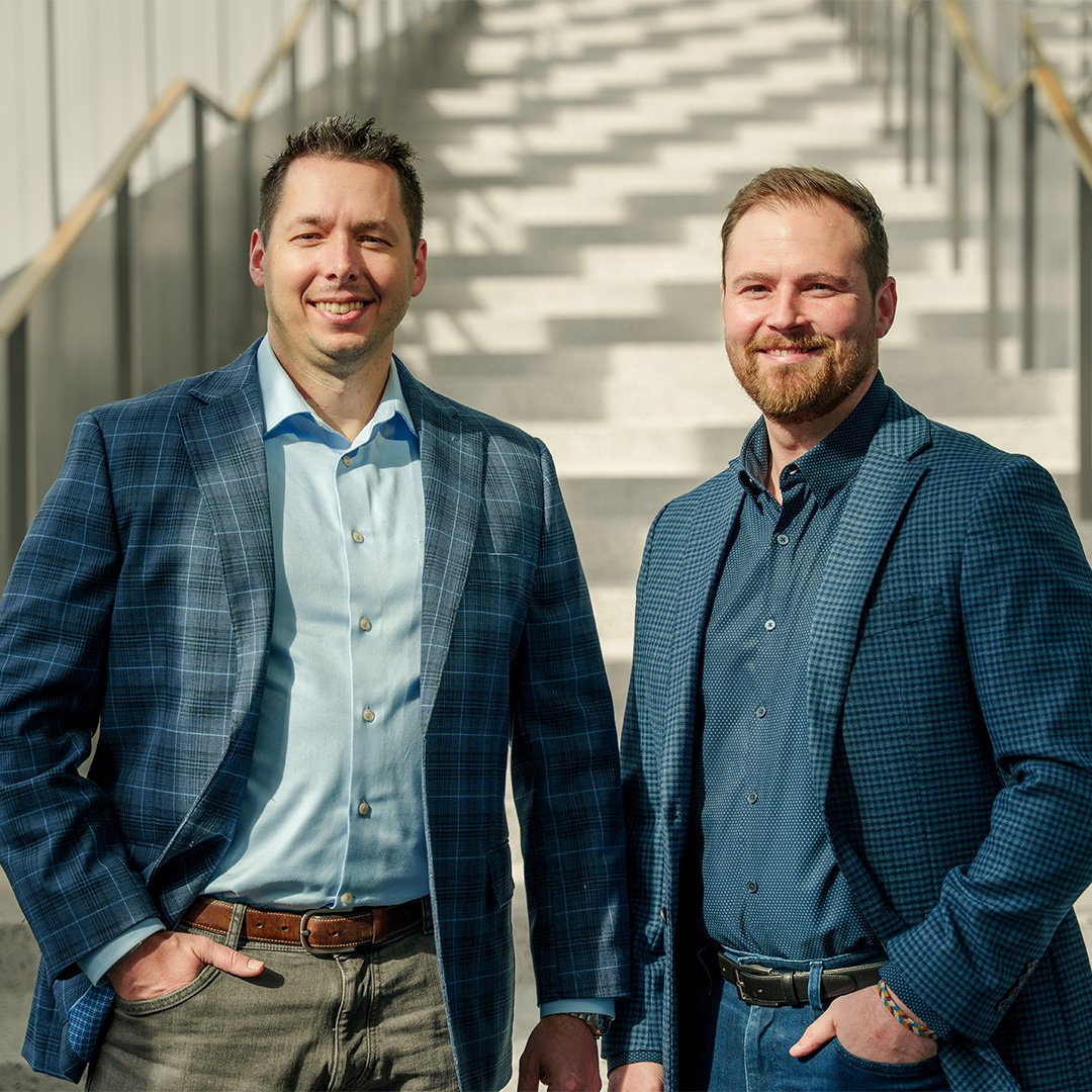 Christian White and Christian Hyatt stand at the base of a staircase in the Tech Square Phase 3 building.