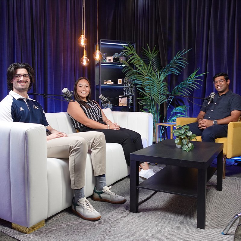 Three MBA students sit down to record a podast episode.