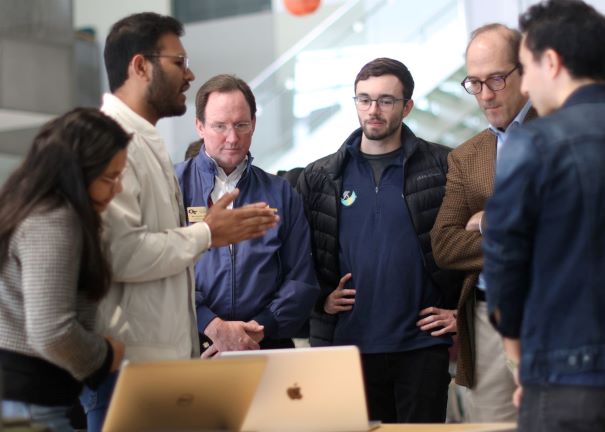 Hacklytics judges listen as a team explains the innovative hack they developed during the 36-hour competition.