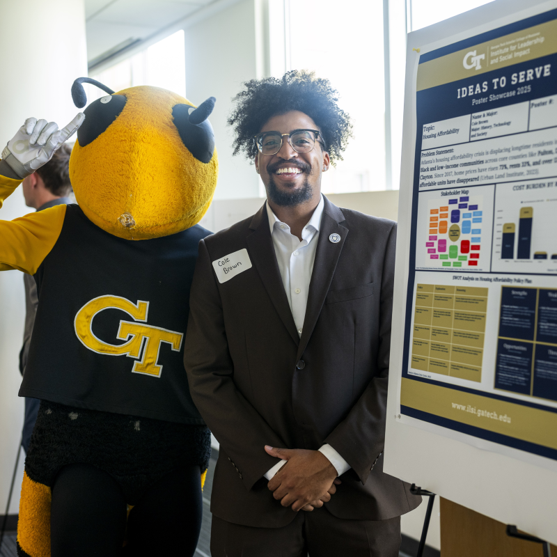 student with Buzz and poster