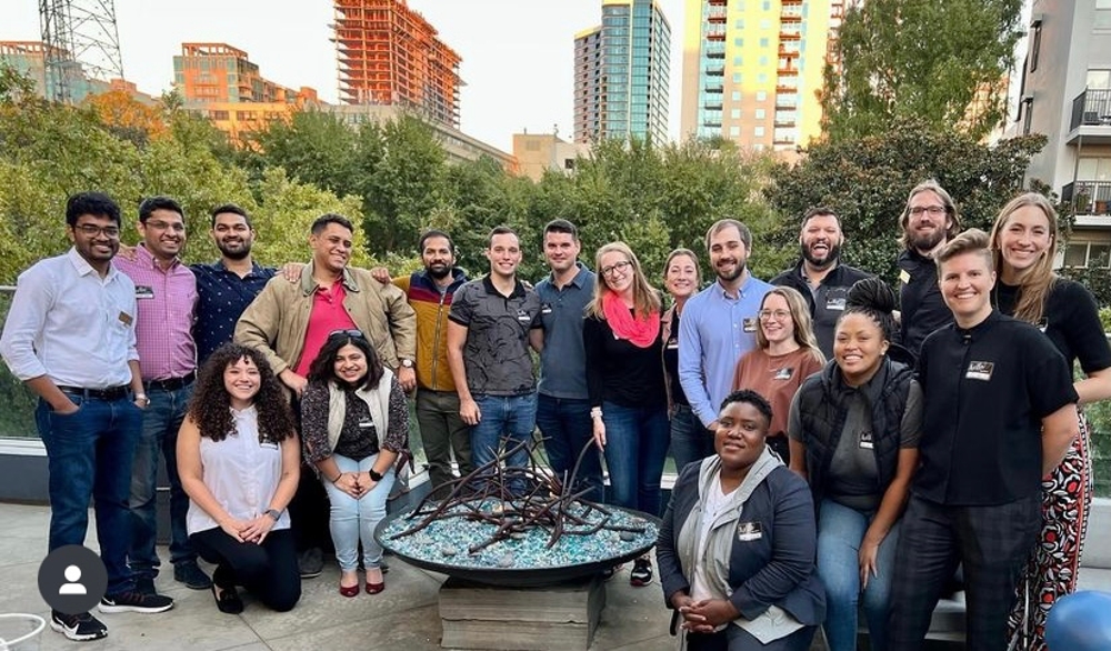 A group of Scheller Pride students gather outside for a networking event