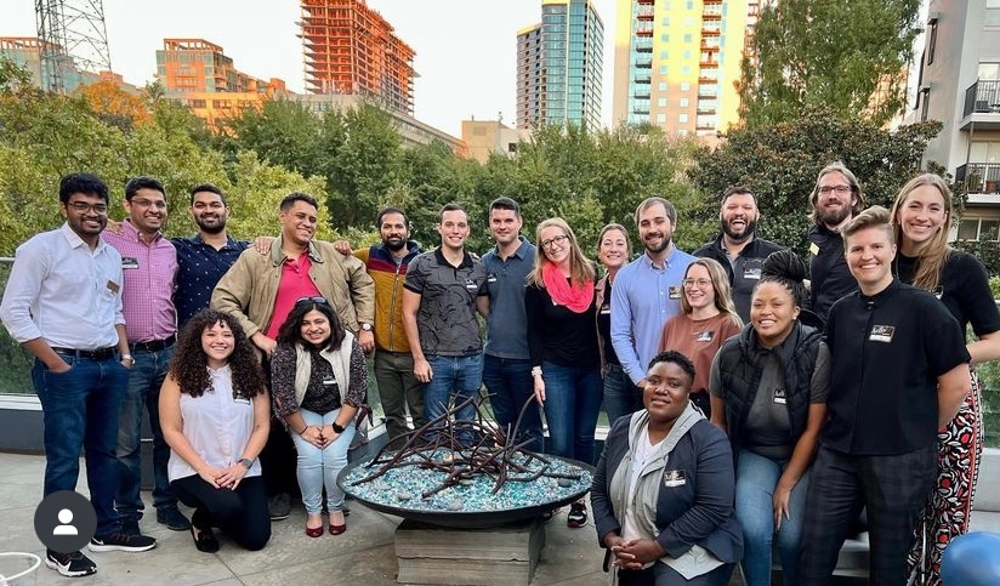 A group of Scheller Pride students gather outside for a networking event