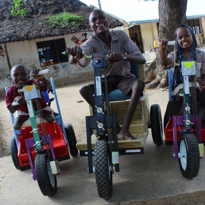 Patients in Kenya smile after receiving Mobility Carts donated by MedShare. (Courtesy Medshare)