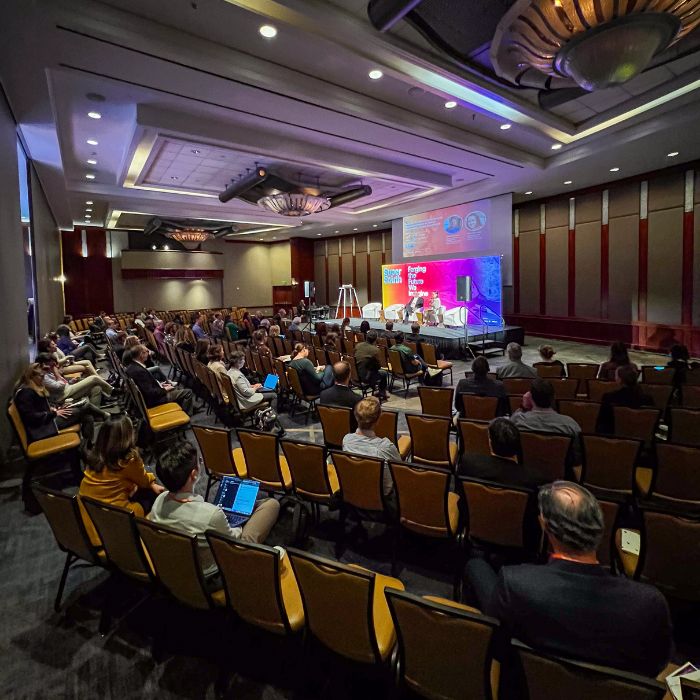 Attendees sitting in a conference hall for Super South