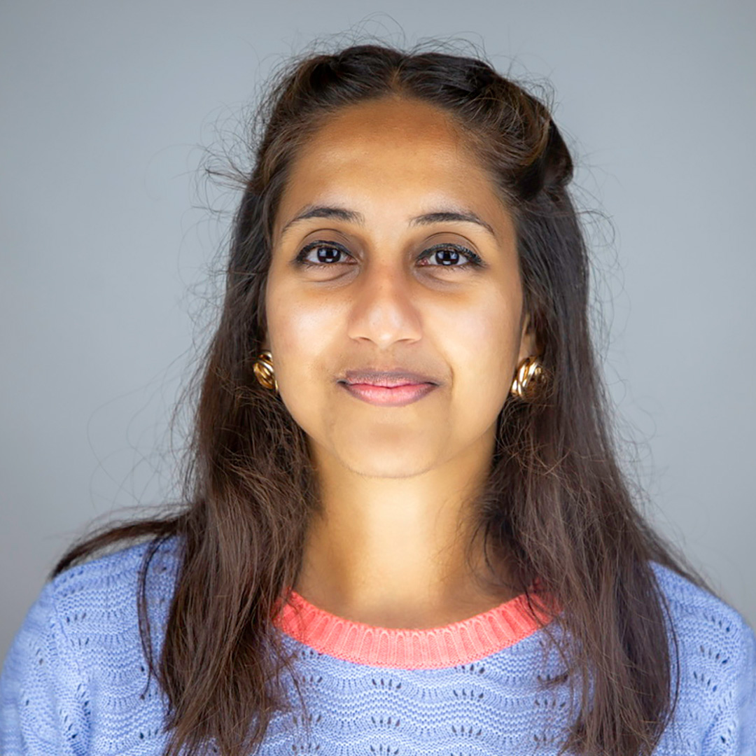 Anisha Rai’s headshot photo; she wears a black suit jacket. 