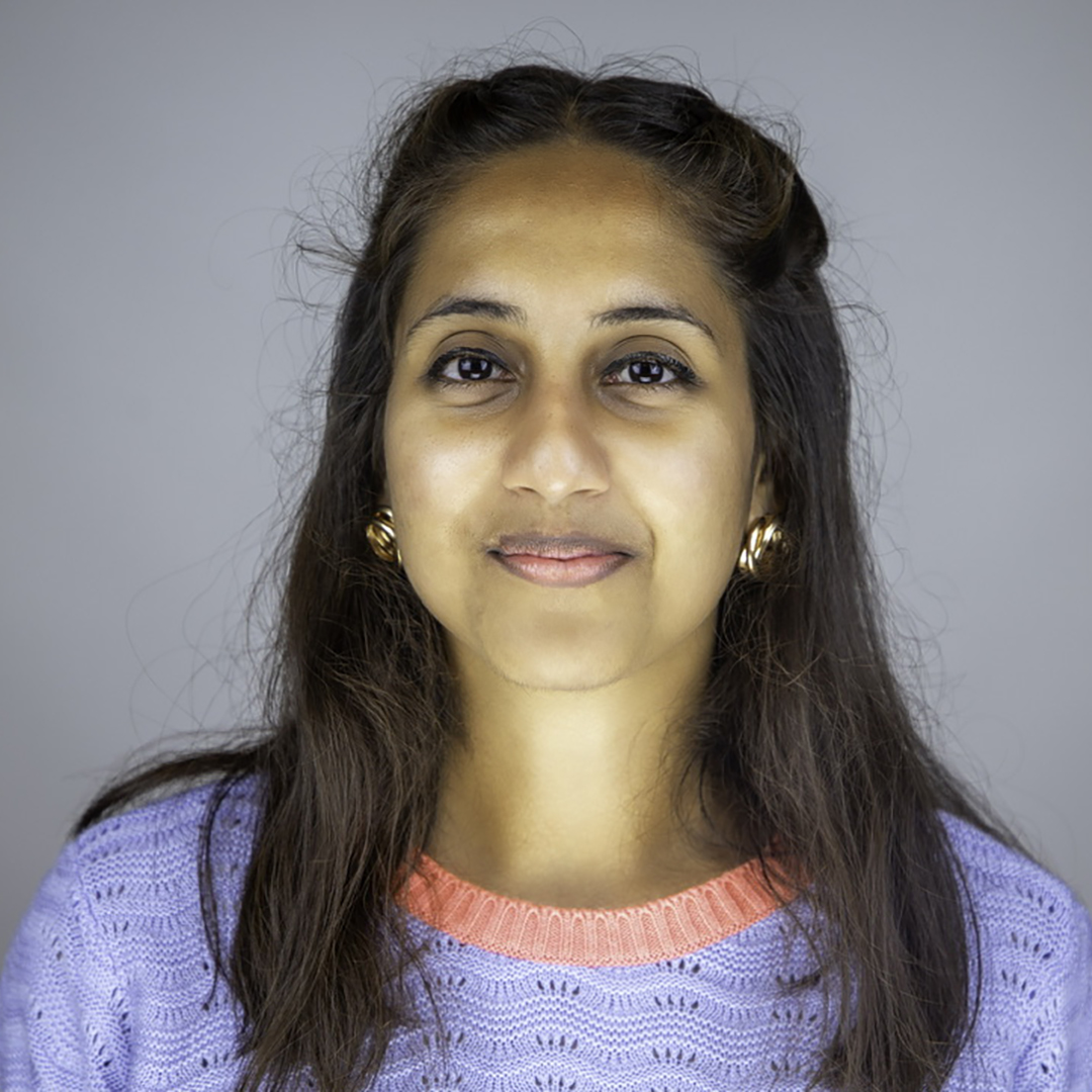 Anisha Rai’s headshot photo; she wears a black suit jacket. 