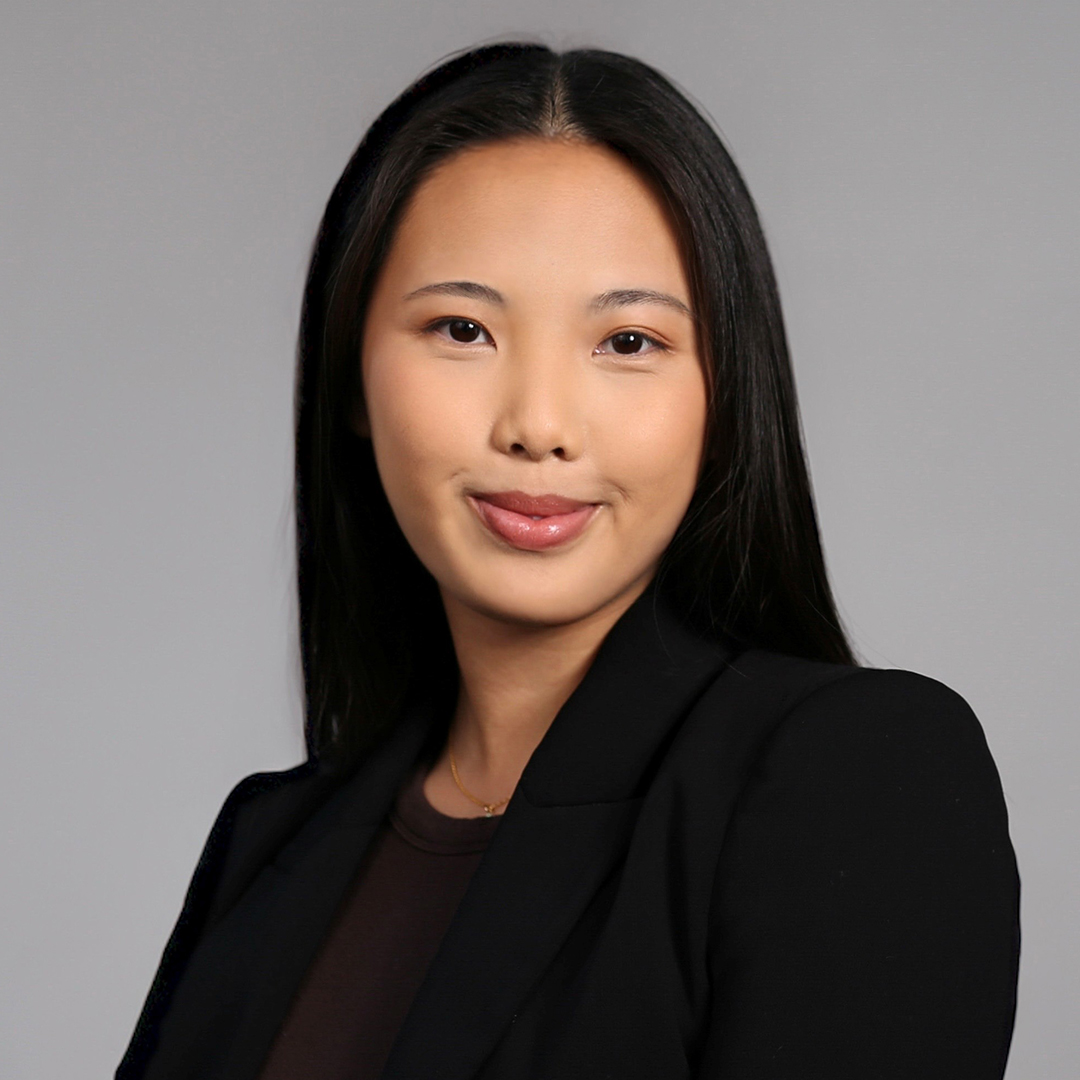 Grace Tang’s headshot photo; she wears a black suit jacket. 